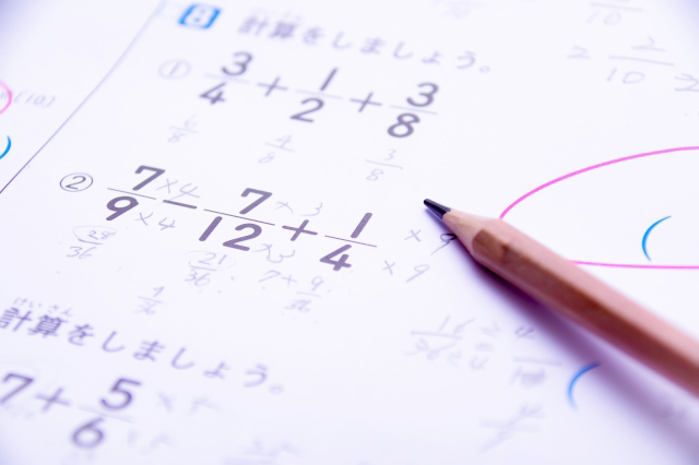 鉛筆と計算式が書き込まれている算数のテキストの画像